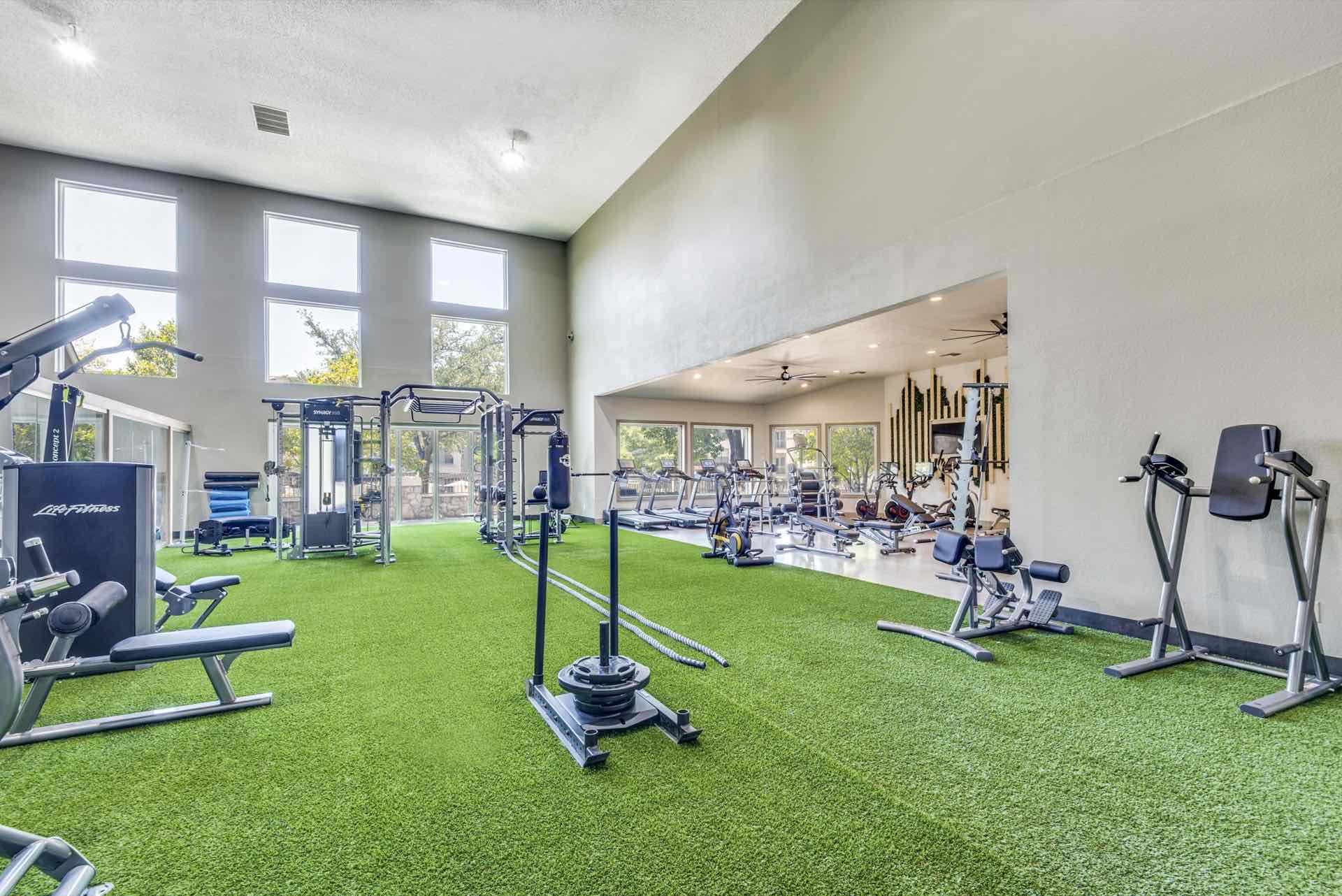 Large fitness room with high ceiling and artificial turf