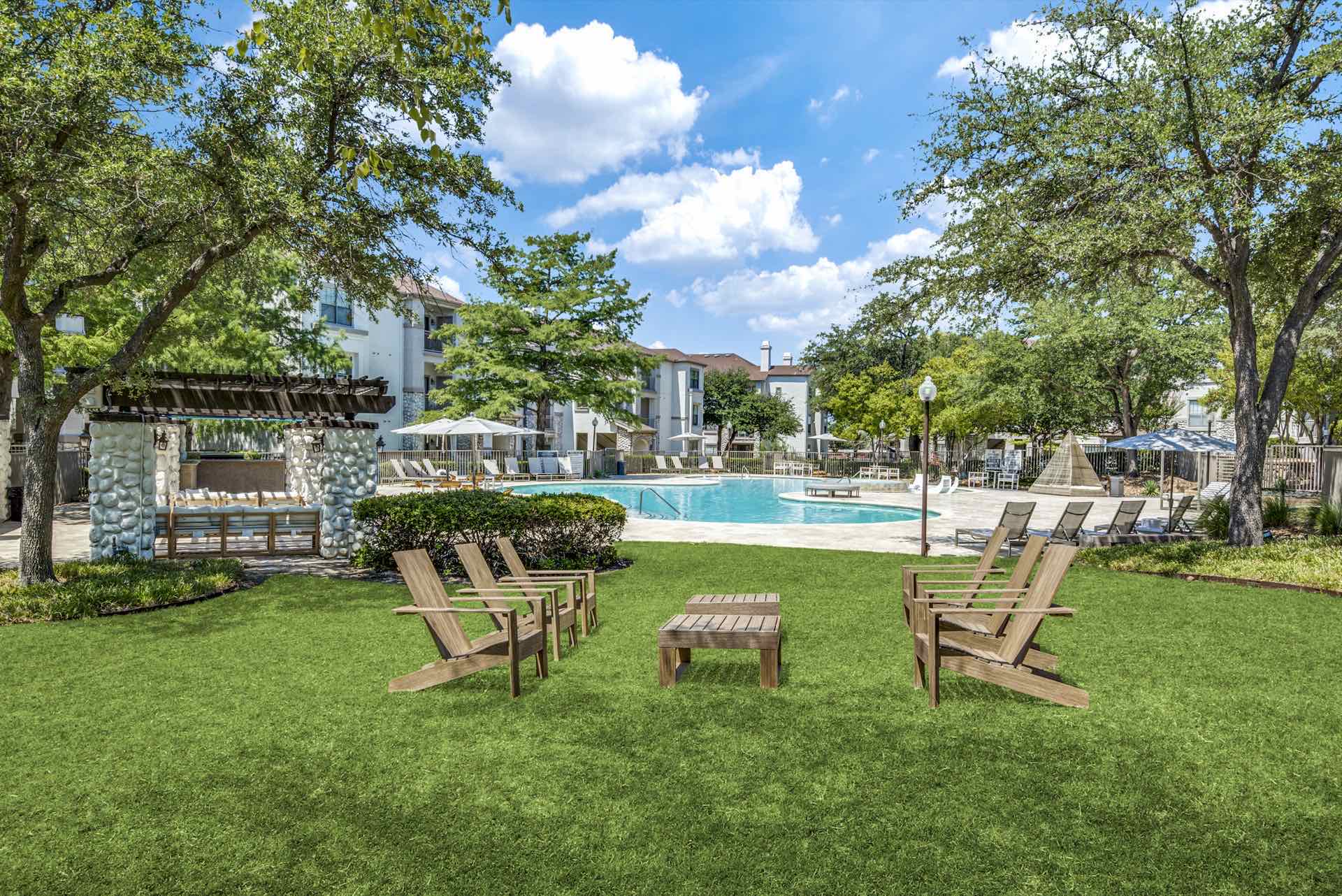 Lawn by pool with Adirondack chairs