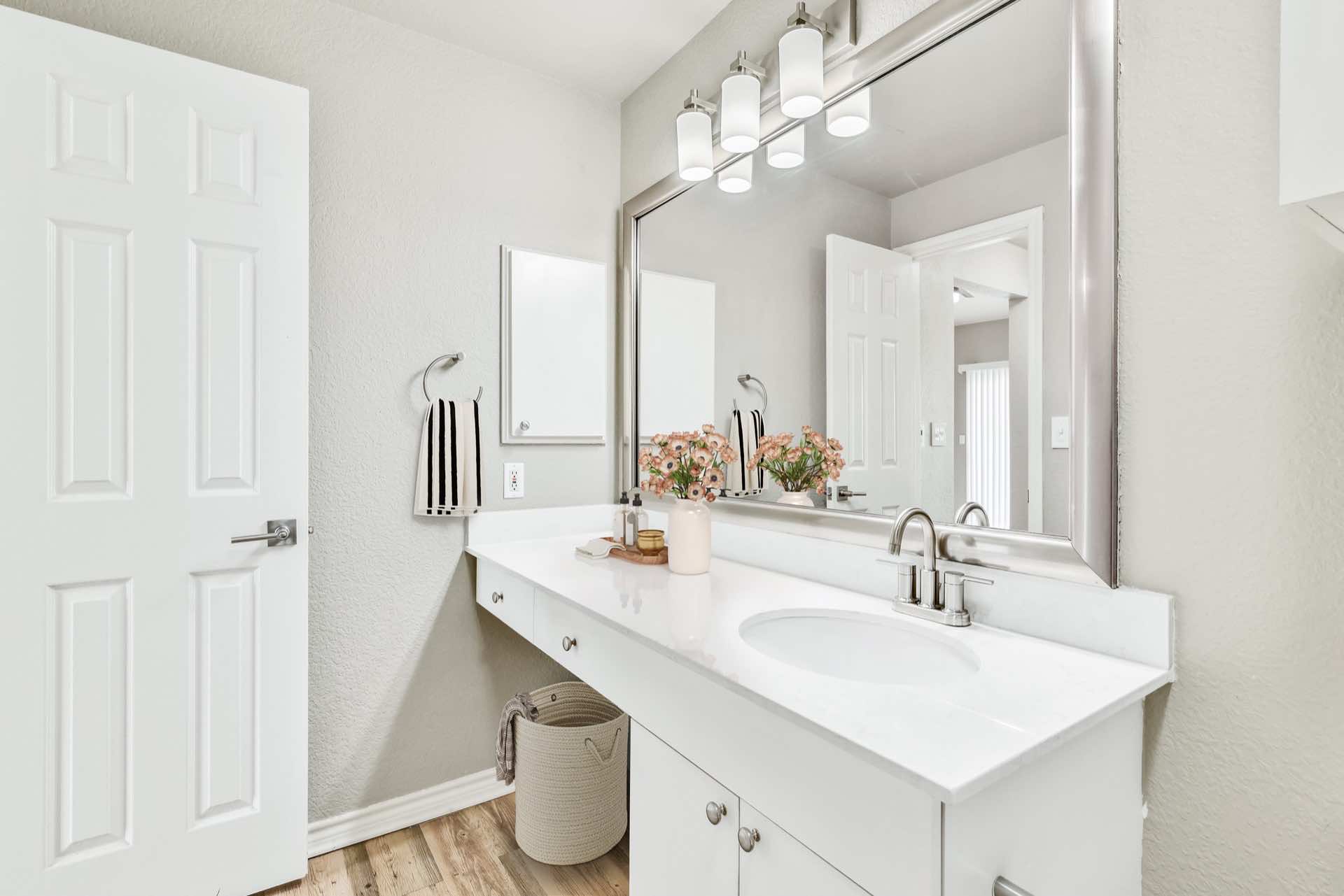 Bathroom white counter and white cabinets